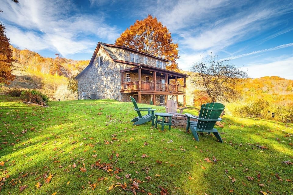 Classic mountain cabin exterior with multiple decks. The perfect basecamp for your next adventure with breathtaking views and inviting outdoor seating.