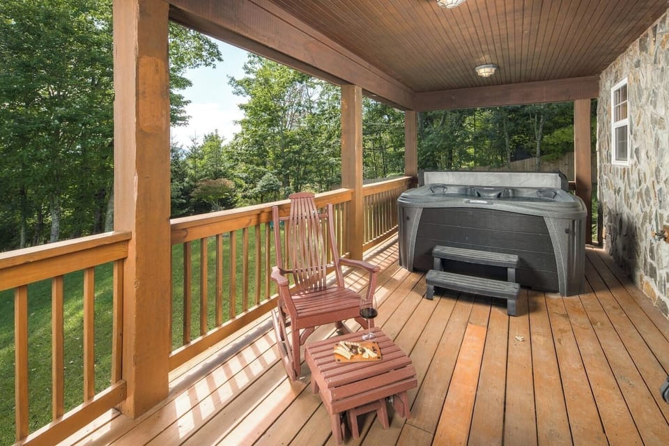Enjoy the ultimate outdoor living experience on this private covered porch with a relaxing hot tub.