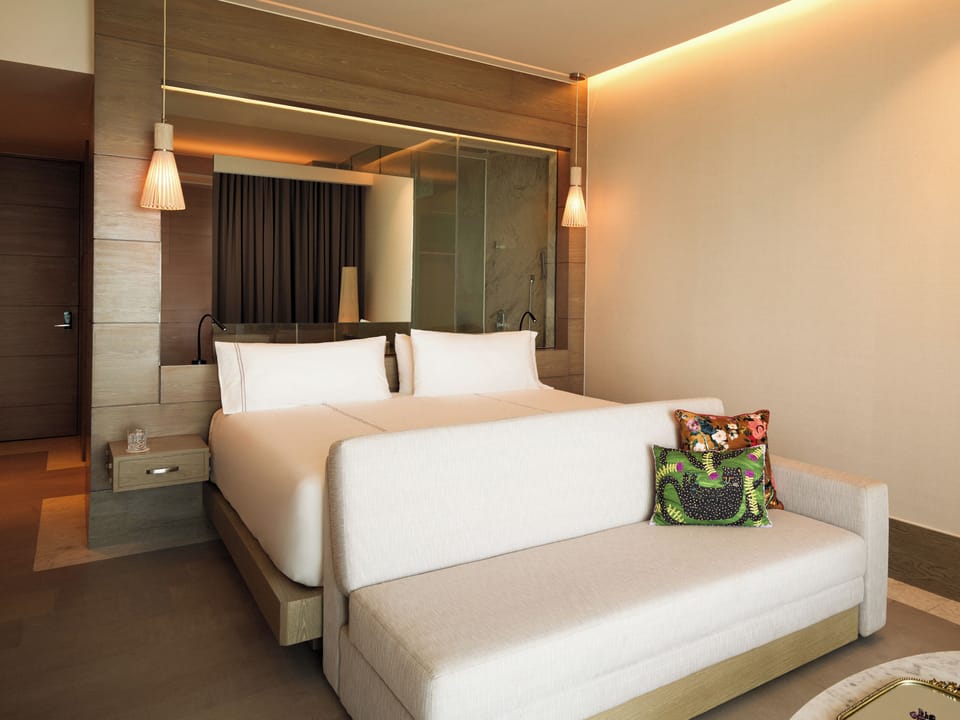 Sink into plush bedding and relax on the cozy lounge sofa.