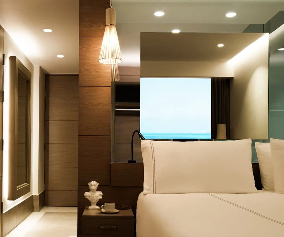 Drift off beneath warm lighting in a quiet, serene retreat.