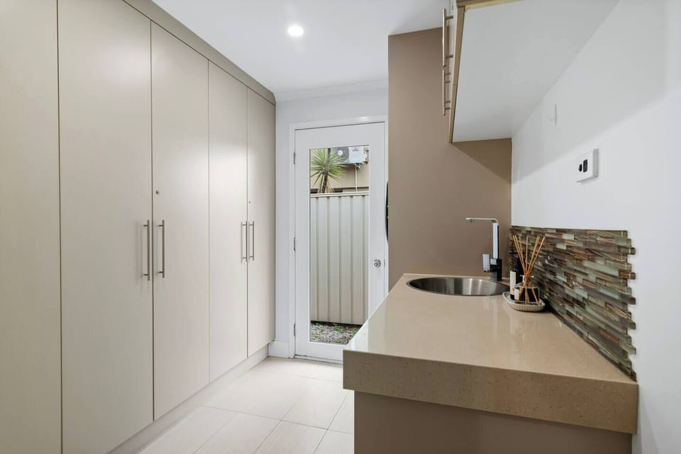 Refresh beachwear and everyday essentials in the laundry, equipped with a washing machine, dryer and ample storage for extended stays.