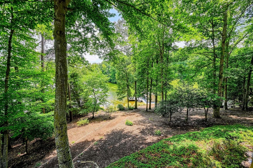 Wooded Surroundings - Mature trees wrap the property, giving the whole back of the home privacy and shade.