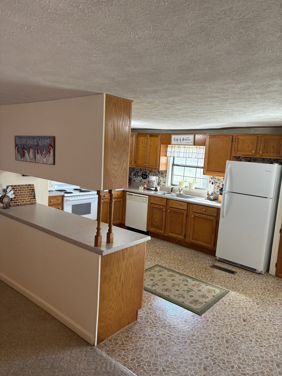 Warm, fully equipped kitchen with breakfast bar and sunny window
