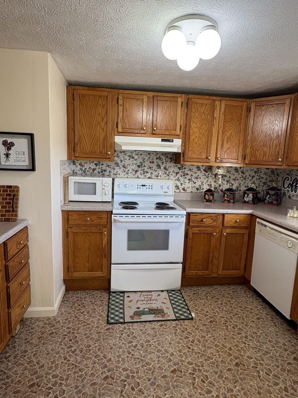 Cozy oak-cabinet kitchen with full appliances and a coffee nook