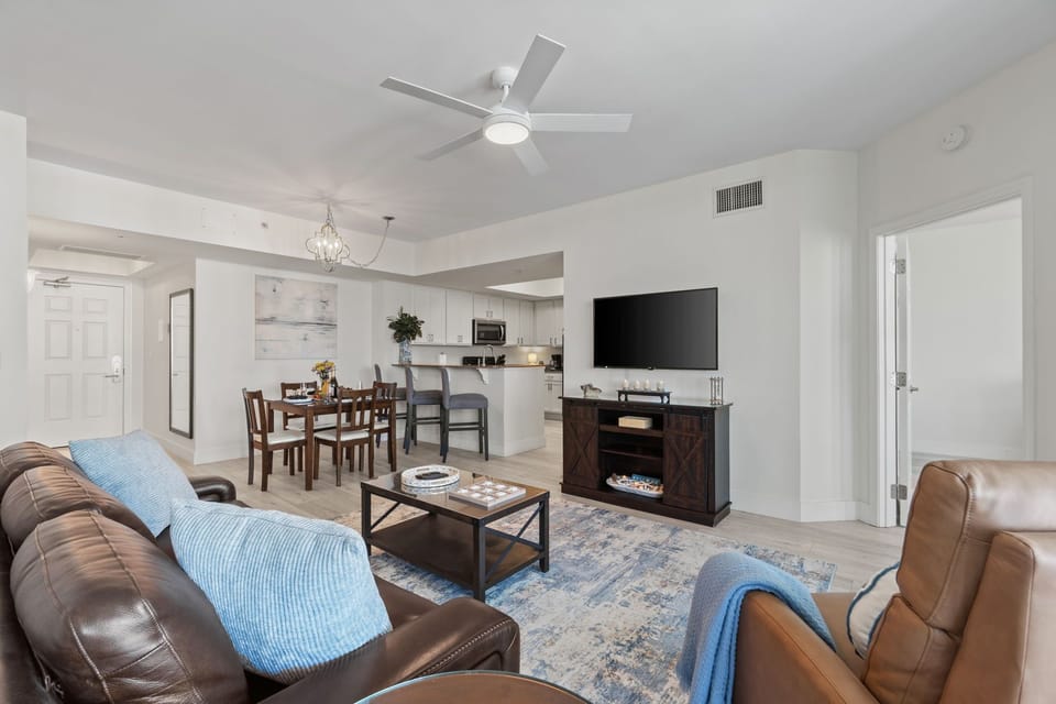 Open living area with cozy seating, TV, and connected gathering spaces
