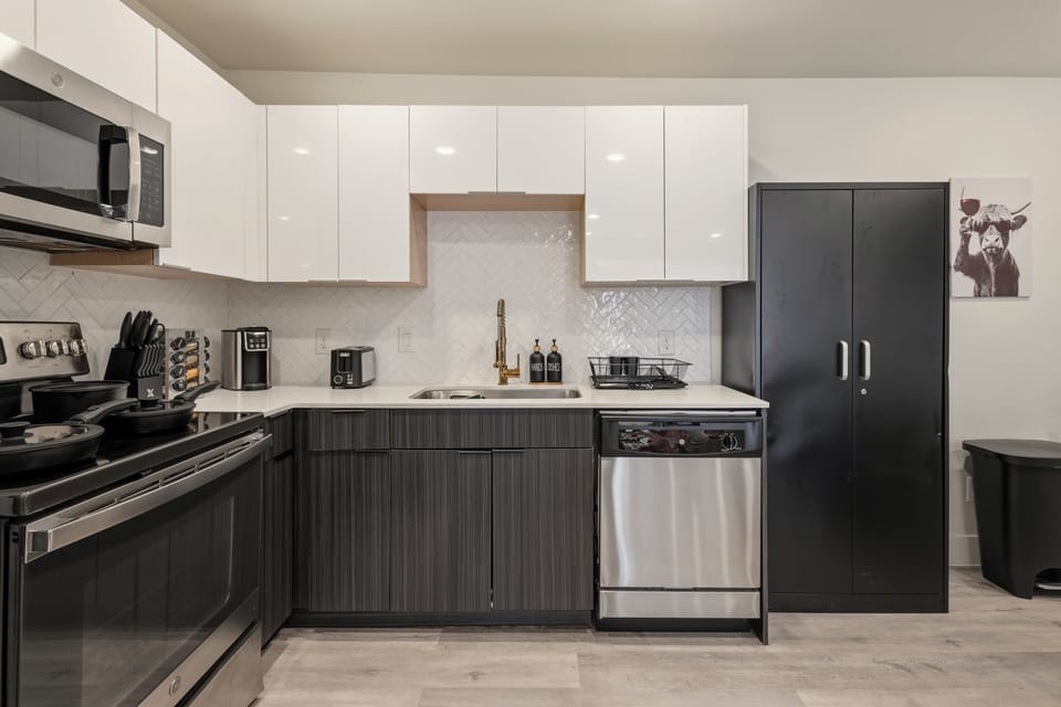 Modern kitchen with ample cabinetry, stainless steel appliances, a full-size refrigerator, dishwasher, coffee maker, and generous counter space for easy meal preparation.