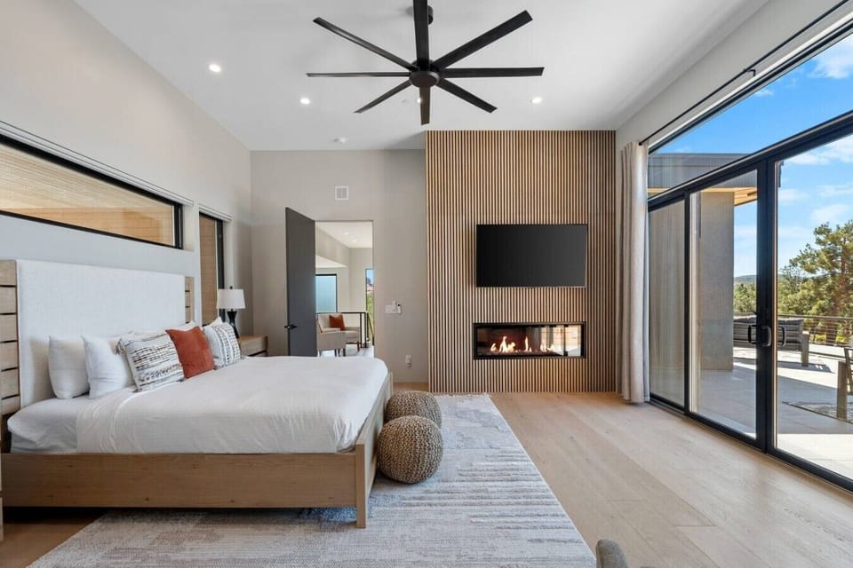 The primary bedroom features a fireplace, TV, king sized bed, and access to front view deck.