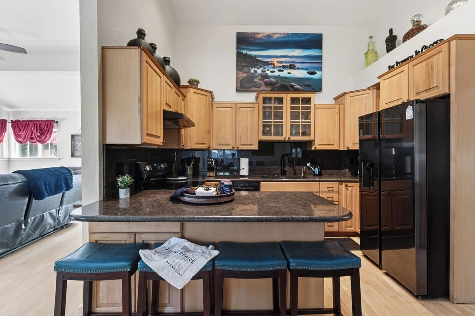Fully equipped kitchen with island seating and easy flow into the main living area. 