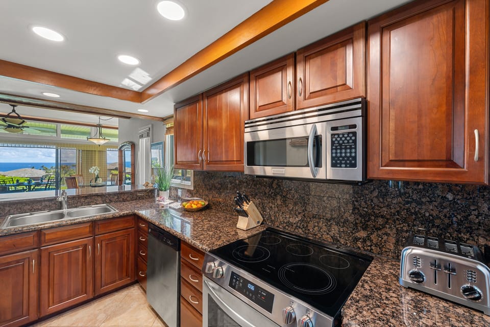 Fully equipped kitchen with stainless steel appliances, granite countertops, and plenty of cabinet storage.
