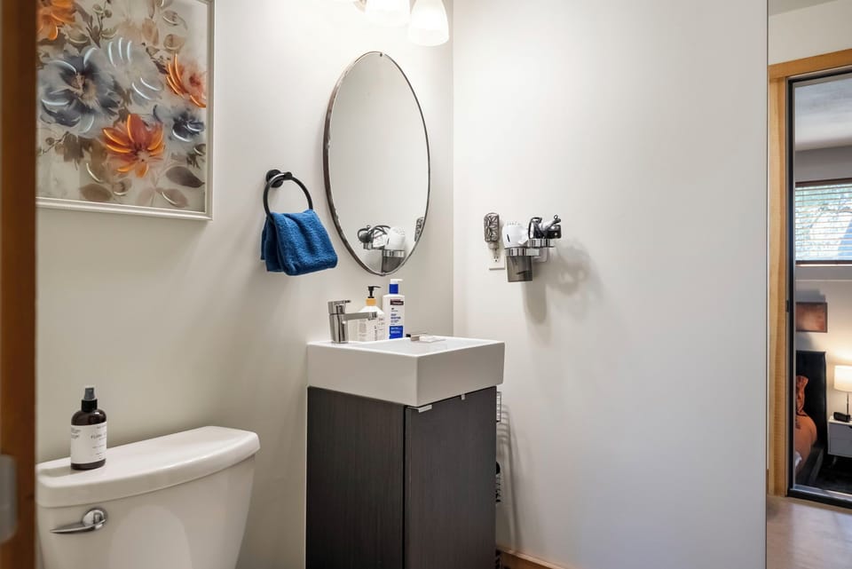 Your modern bathroom features a sleek vanity, ample lighting, and soft towels—everything you need to refresh after a day of exploring.
