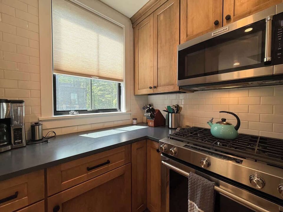 Stainless appliances, warm wood cabinetry, and a gas range make this a kitchen that's actually worth cooking in.