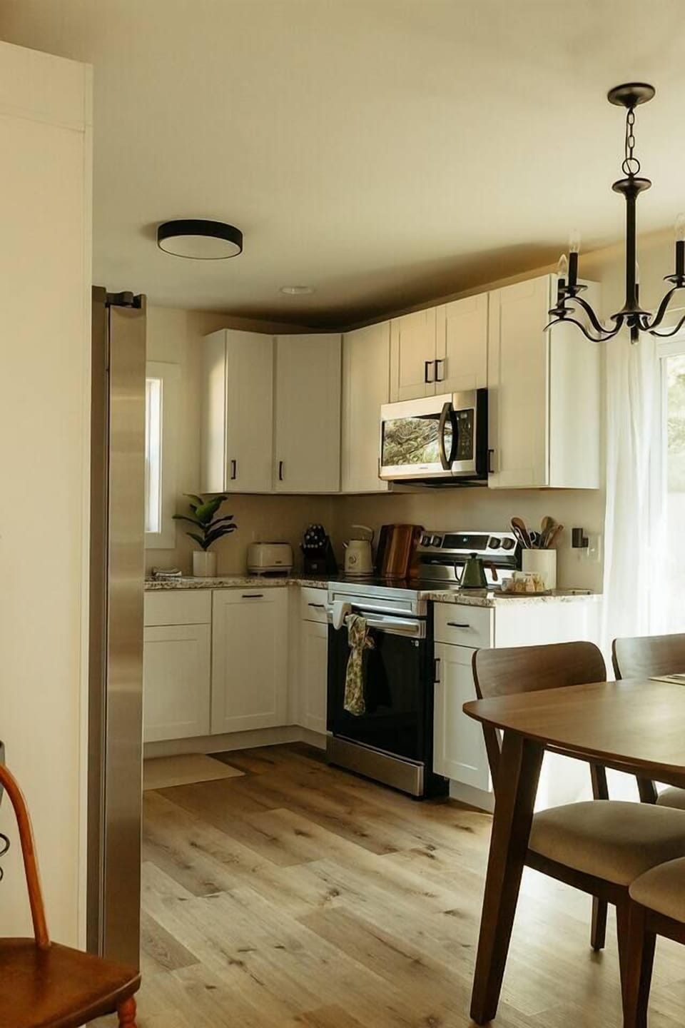 All new appliances and care in the details makes this space especially cozy, bright, and welcoming. An outdoor deck off the kitchen provides an additional dining experience with seating for five. 