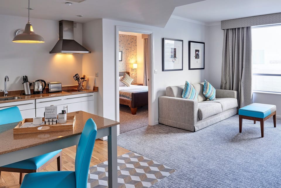 Spacious suite with kitchen, cozy seating, and inviting open layout.