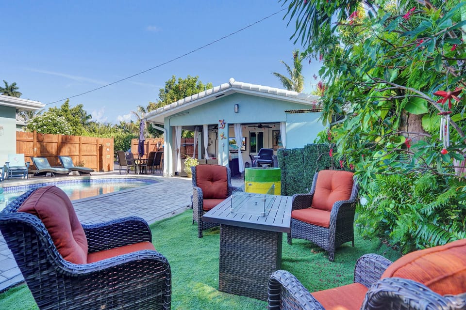 Outdoor lounge set surrounded by tropical plants.