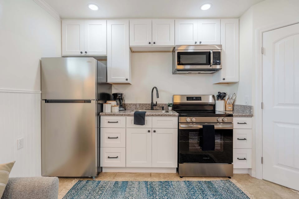Updated kitchenette with stove, oven, microwave, and full-size fridge