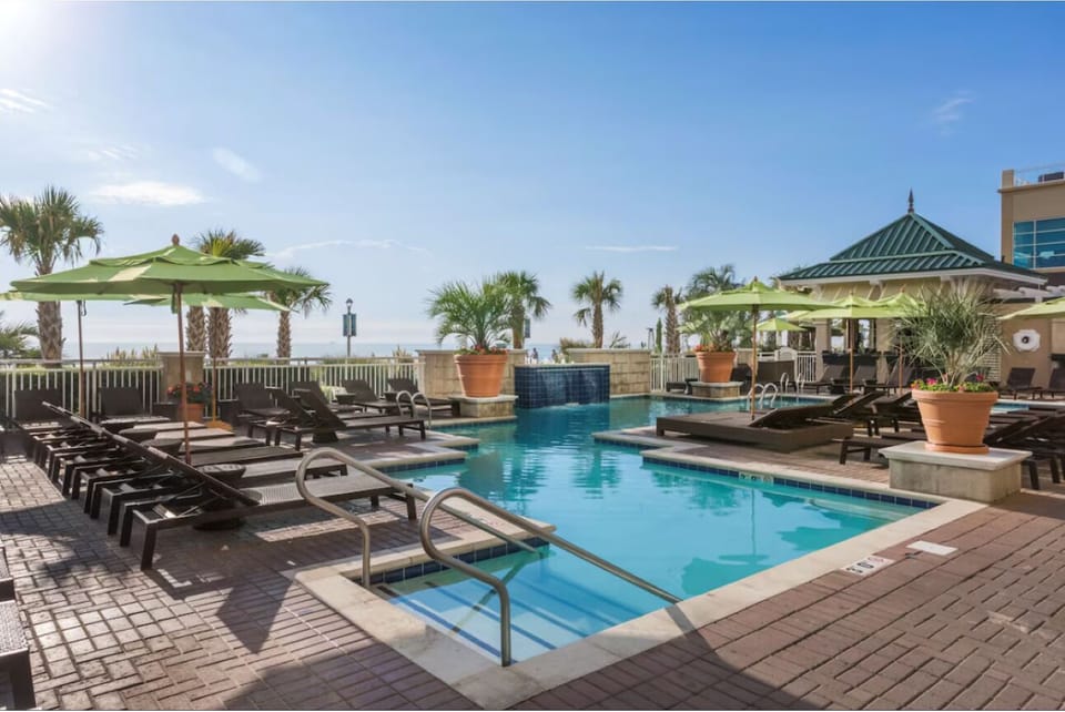 Slip into sparkling water surrounded by breezy palms and shade.