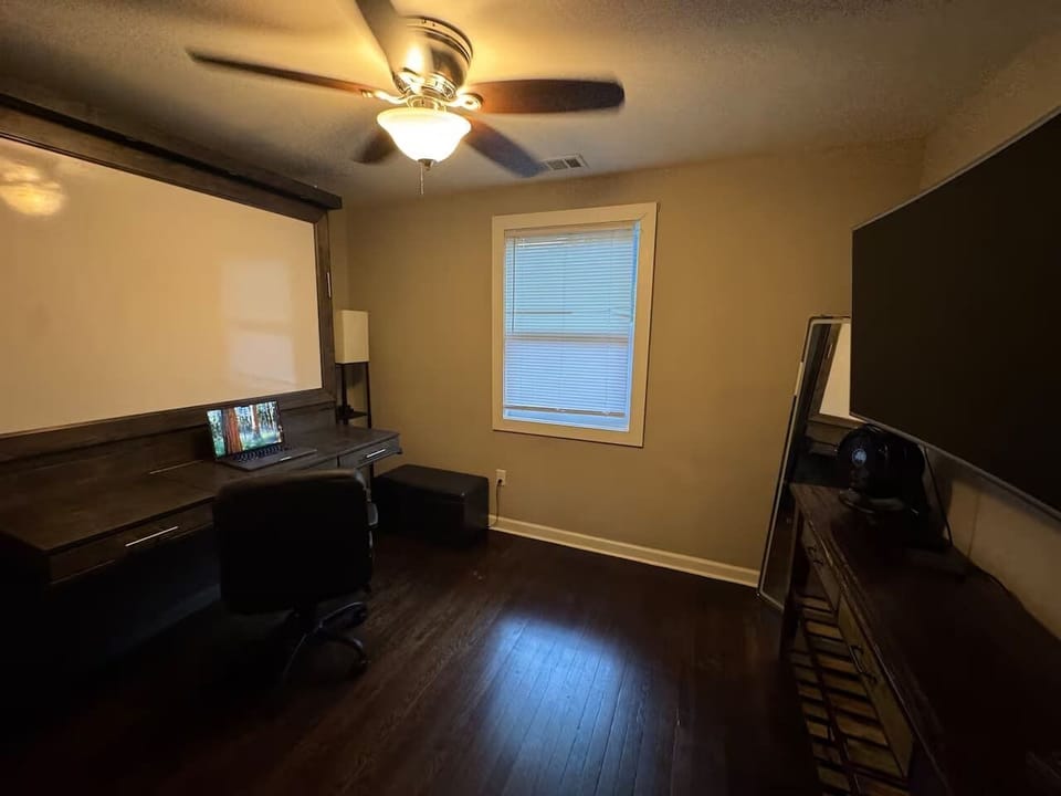 Multi-use room featuring a desk that converts into a Murphy bed with a memory foam queen mattress.