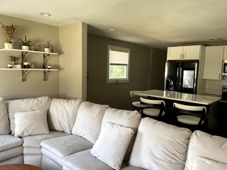 Spacious living room with plenty of seating, perfect for relaxing, chatting, or movie nights together.