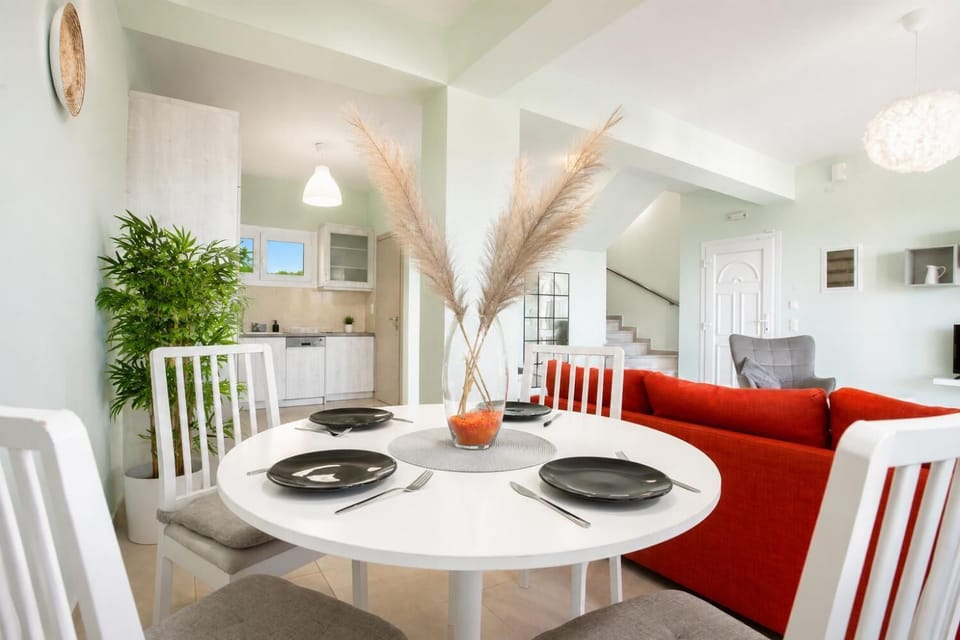 Bright dining area with a stylish table setting, open-plan kitchen, and comfortable living space.