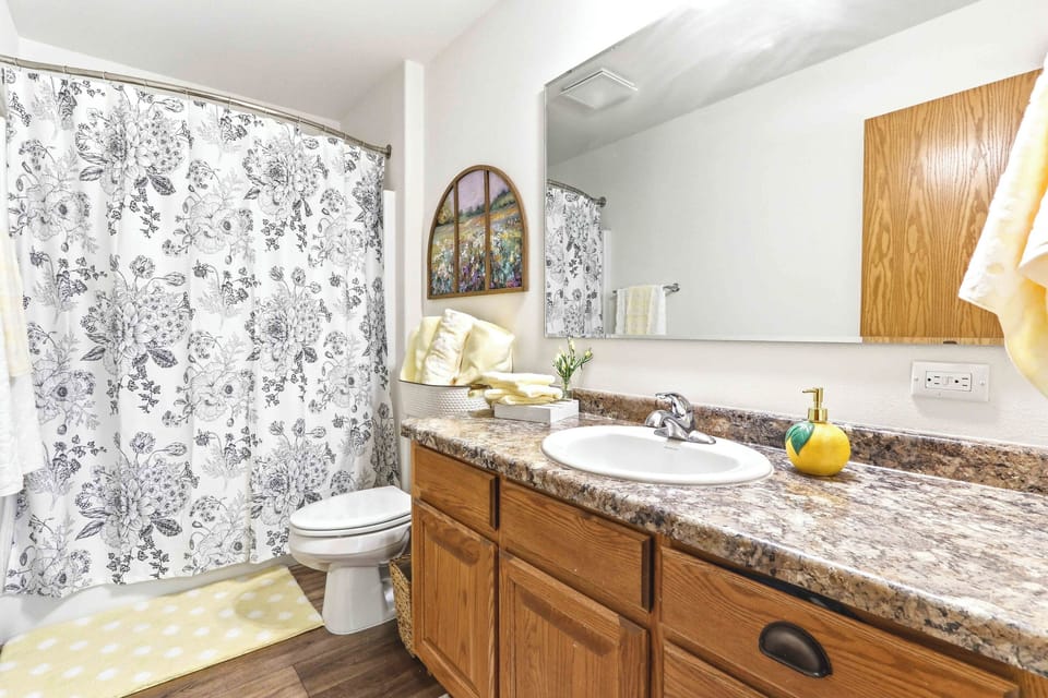 Refresh and unwind in a clean, cheerful bathroom with warm finishes and thoughtful touches for an easy stay.