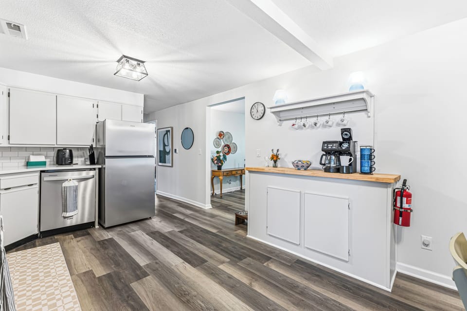 Bright modern kitchen with stainless appliances and a cozy coffee station