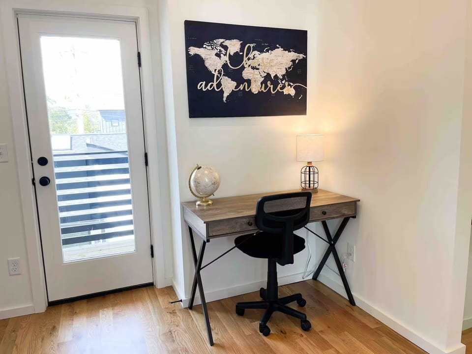Office space welcomes you off of the stair landing with balcony access