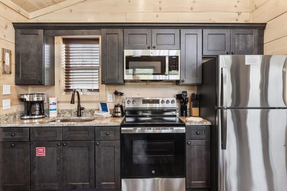 Full kitchen with stove, refrigerator, drip coffee maker