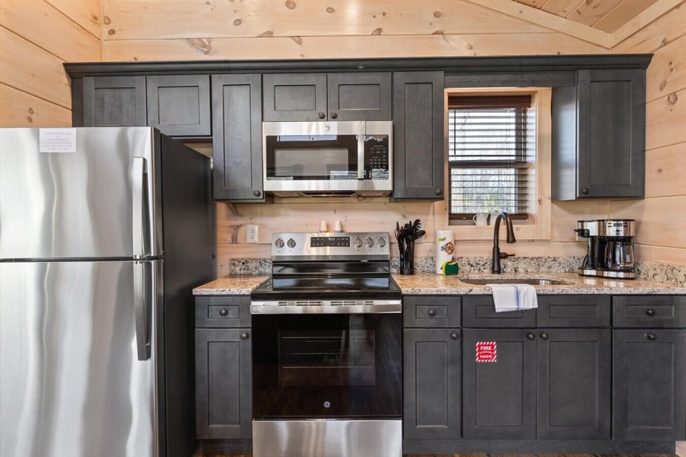 Full kitchen with stove, refrigerator, drip coffee maker