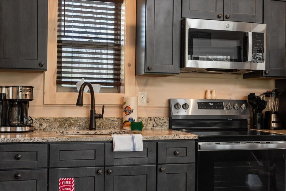 Full kitchen with stove, refrigerator, drip coffee maker