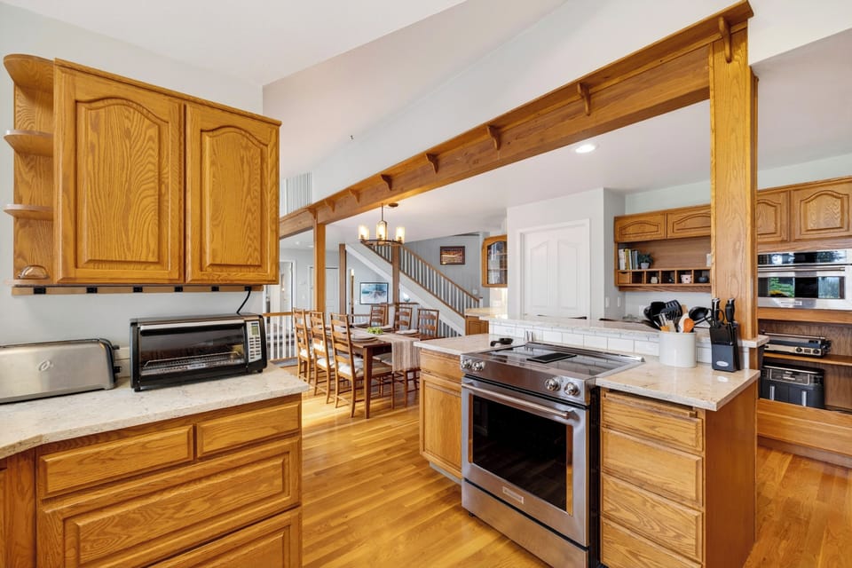 Full kitchen with stainless steel range, generous prep space, and an easy view into the dining area.