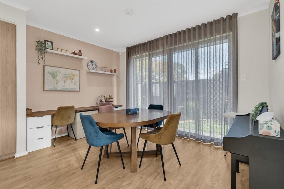 Bright dining area with built-in desk and garden outlook
