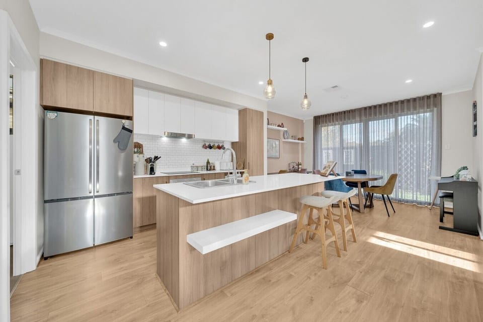 Open-plan kitchen and dining flowing to garden views