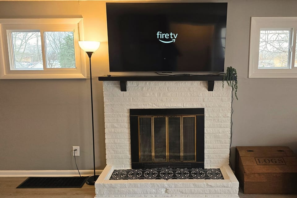 Cozy white-brick fireplace with Fire TV—perfect for movie nights