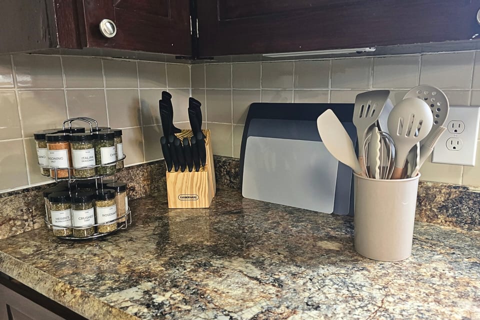 Chef-ready prep corner with spices, knives, boards, and utensils.