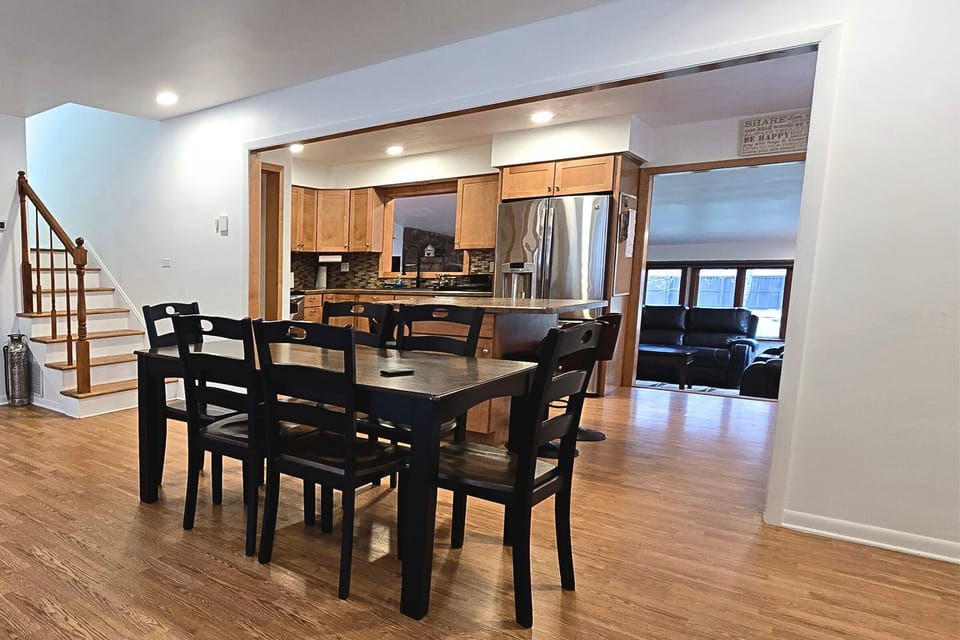 Open-concept kitchen & dining with island; cozy lounge adjacent.
