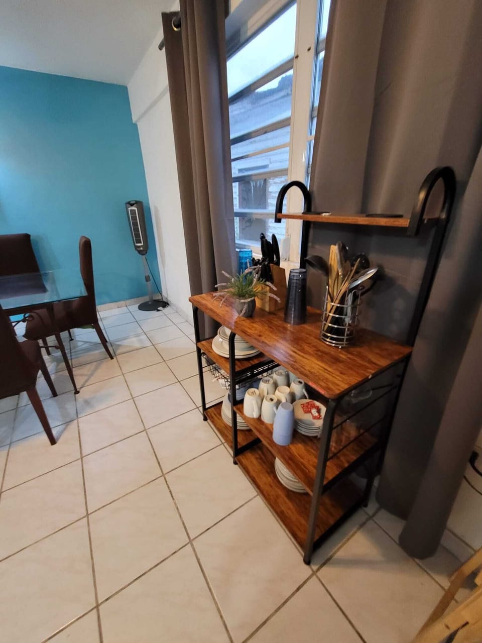Bright dining nook with modern shelving and fully stocked essentials
