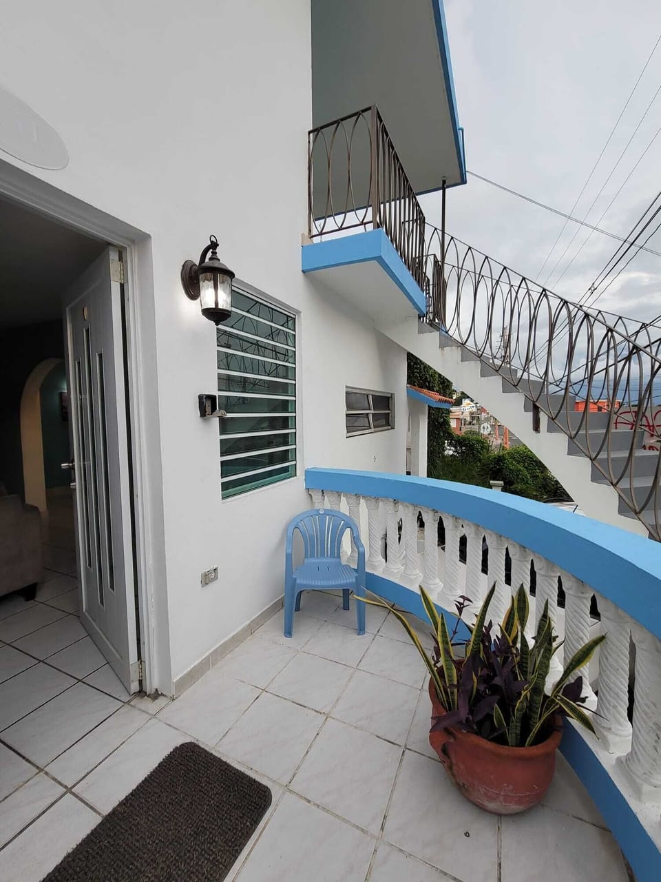 Bright tiled terrace with blue accents and inviting outdoor seating