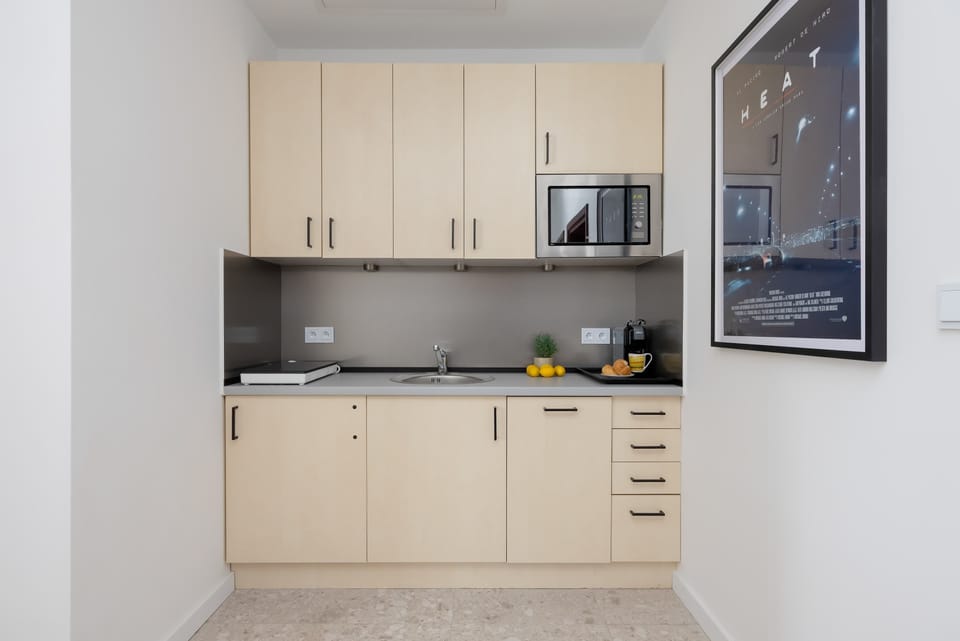 Fully equipped kitchenette with modern appliances and ample storage space.
