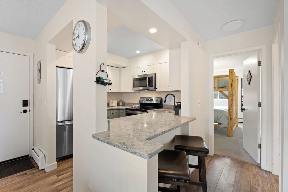 Your fully equipped kitchen welcomes you with modern appliances, a breakfast bar for quick bites, and an open layout connecting seamlessly to your cozy bedroom retreat.