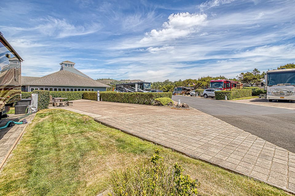 A well-maintained property featuring spacious parking and landscaped grounds, offering convenient access for guests arriving by vehicle or RV.