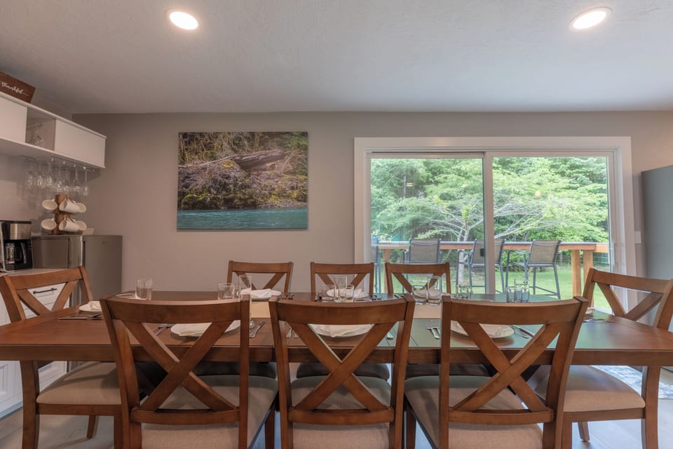 Large dining table next to sliding doors for scenic indoor-outdoor meals.