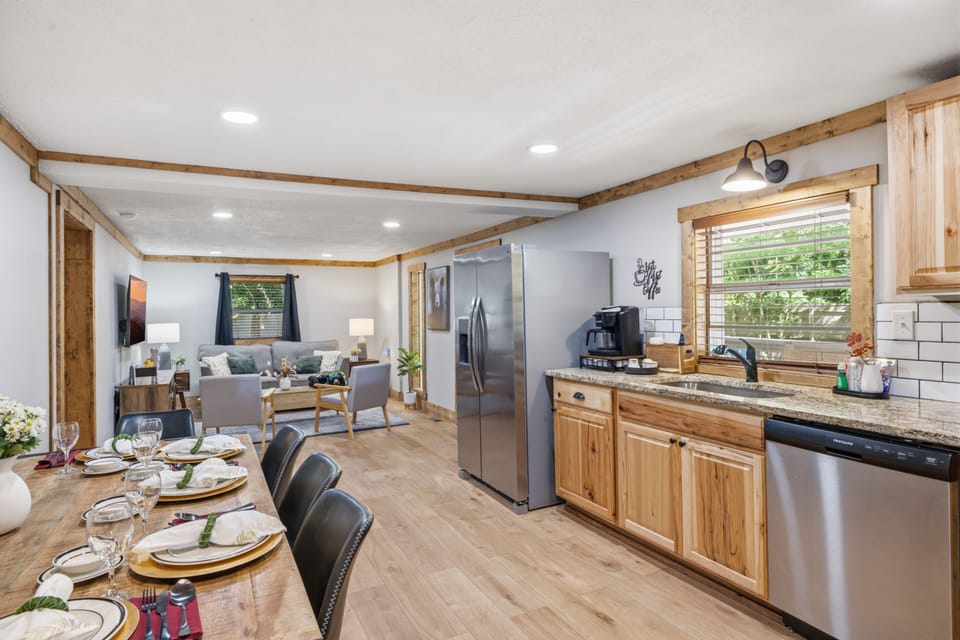 Open-concept kitchen, dining & cozy living space with warm rustic charm