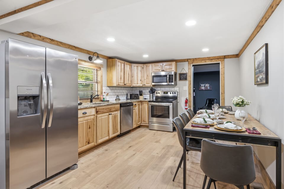 Bright rustic kitchen with stainless appliances and dining for six