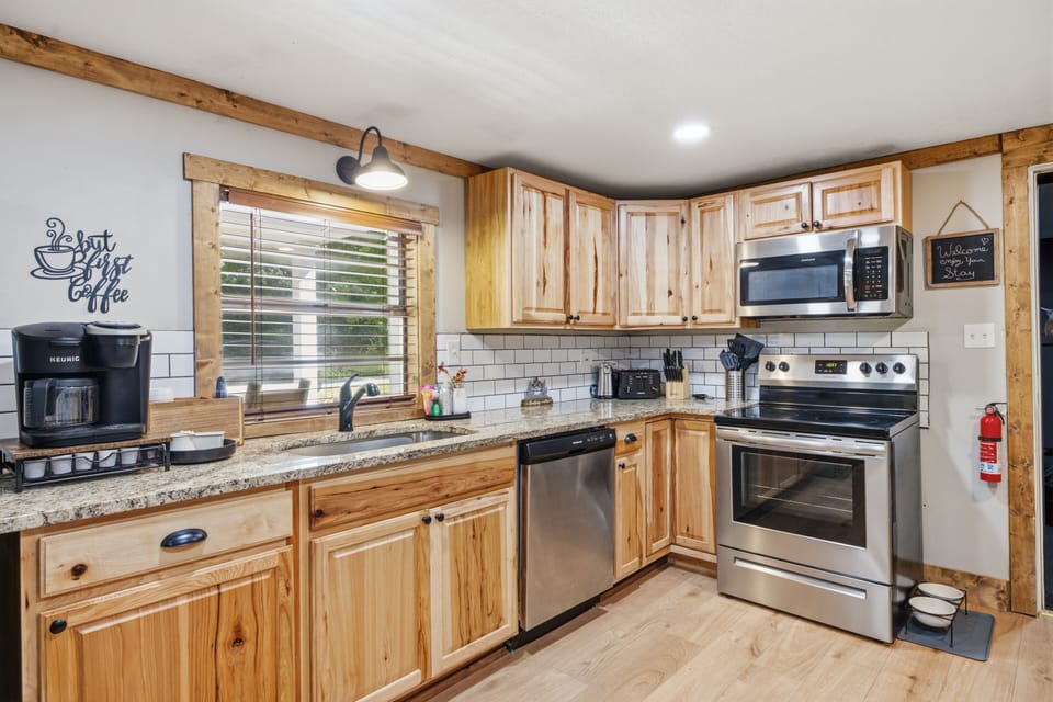 Rustic-modern kitchen with stainless appliances and a sunny coffee nook