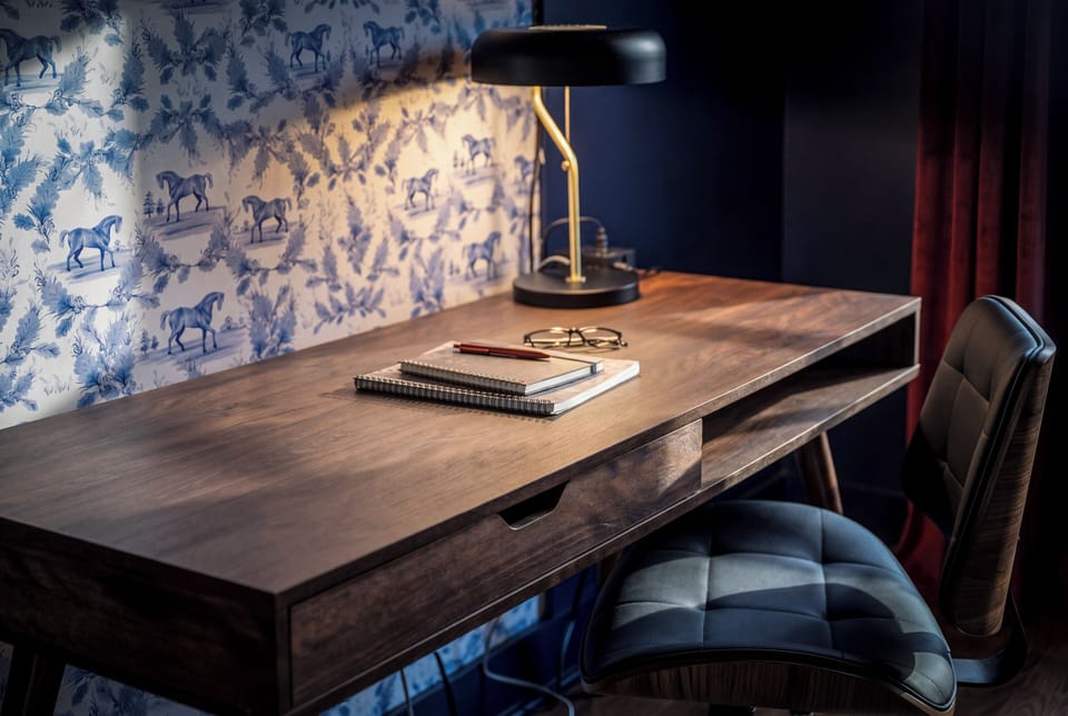 Stylish workspace with sleek desk, leather chair, and designer lighting