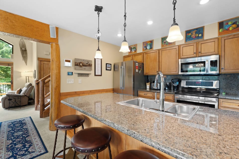 Your fully-equipped kitchen opens to a bright living area, inviting you to gather, cook, and make yourself at home in this welcoming space.