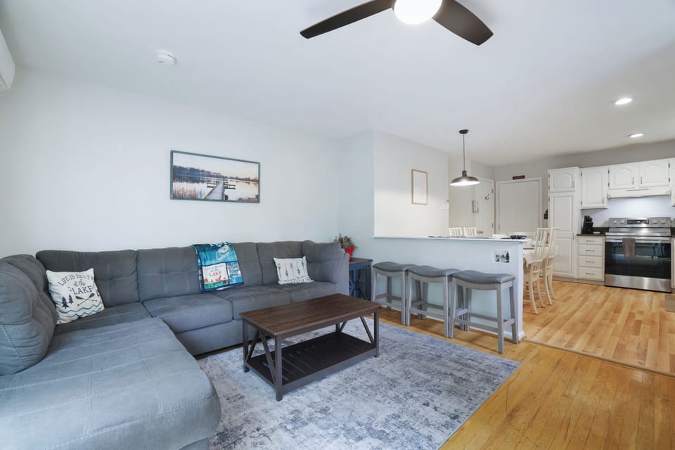 Bright open living room with large sectional and breakfast bar seating