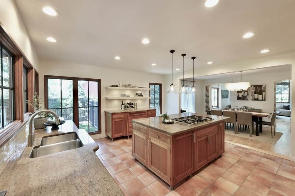 Anchored by a massive island and high-end commercial appliances, it’s an inviting space where friends can sit and enjoy a cocktail while dinner is sizzling away.