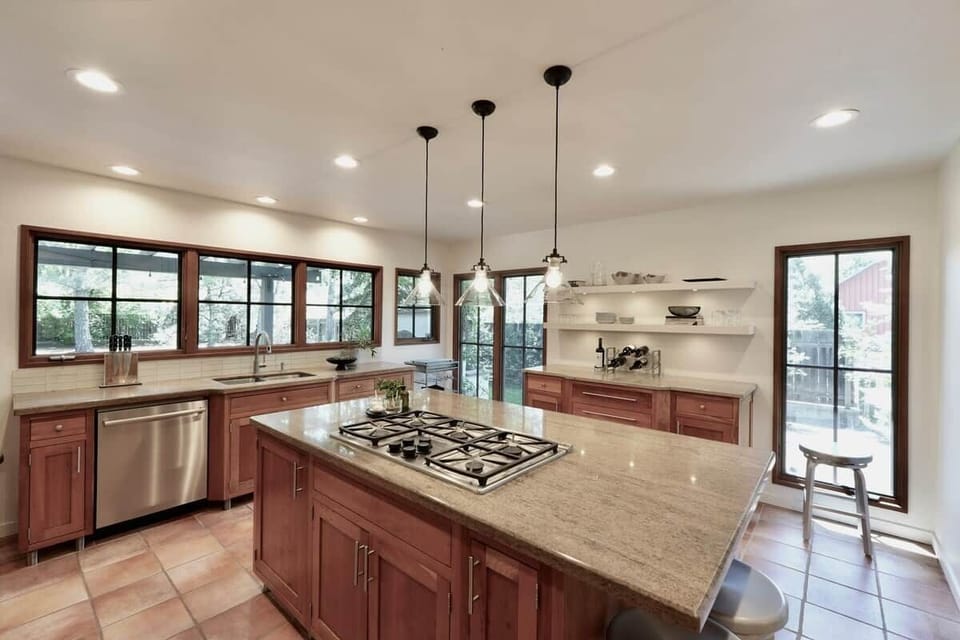 Anchored by a massive island and high-end commercial appliances, it’s an inviting space where friends can sit and enjoy a cocktail while dinner is sizzling away.