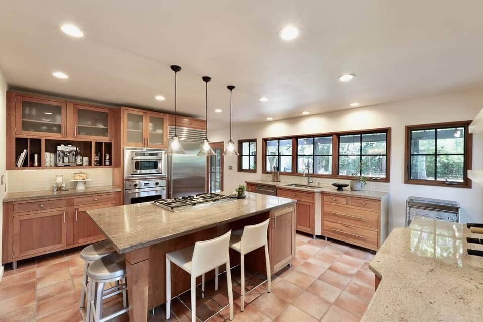 Our standout, fully equipped chef’s kitchen. Anchored by a massive island and high-end commercial appliances, it’s an inviting space where friends can sit and enjoy a cocktail while dinner is sizzling away.